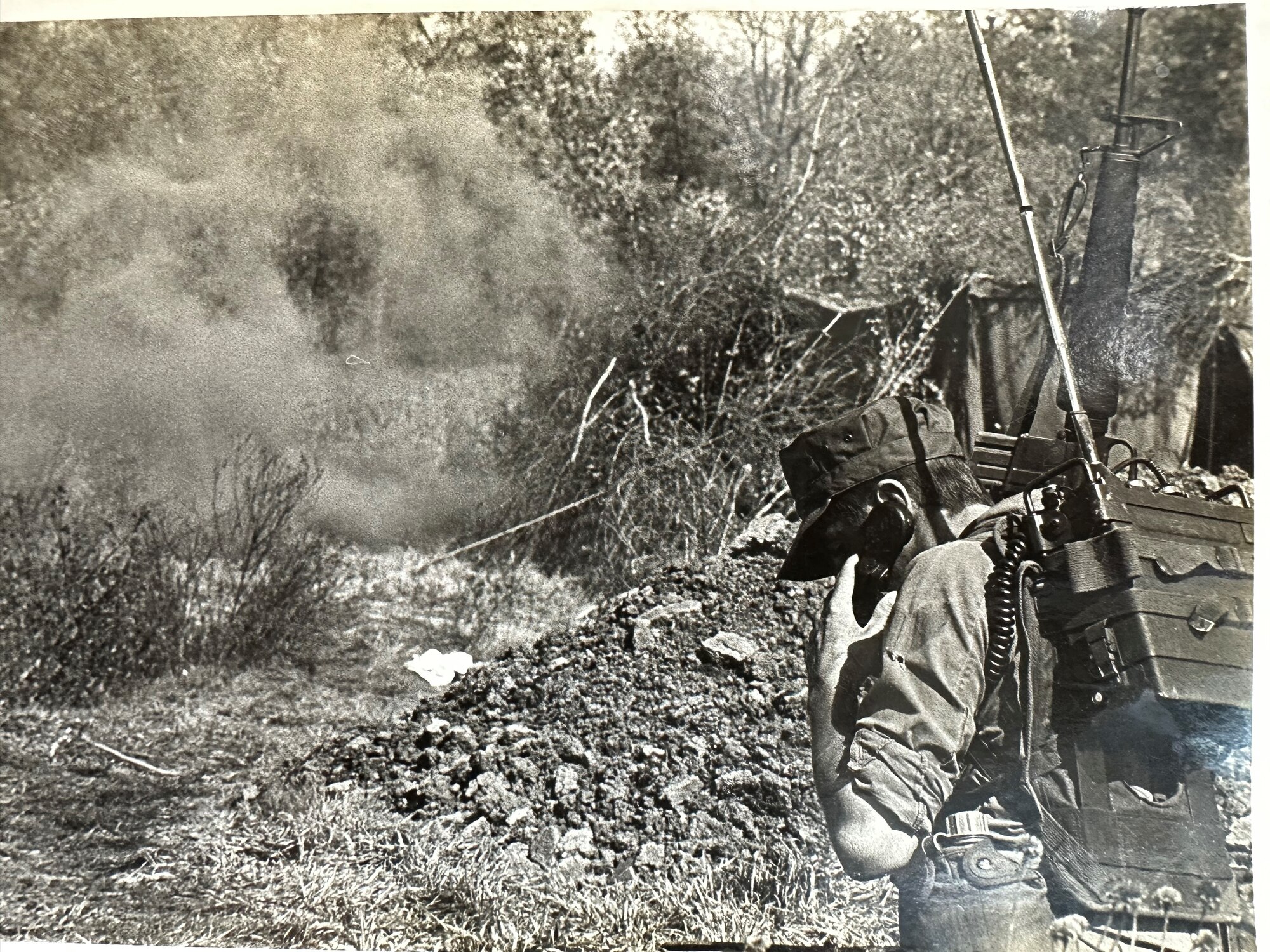 A Security Policeman reports enemy activity via a man-packed tactical radio during air base ground defense training at Scott in April 1983.  Lt. Col. Charles R. Piver, 375th Security Police Squadron commander, would implement a rigorous combat training program would be put to real-world use within 6 months of this event. (Courtesy Photo)
