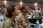 (L) Navy Lt. Cmdr. America Estevez-Guerrero, Tampa MEPS commander, listens intently during a presentation at the USMEPCOM Leadership Conference. The conference brought leaders from all MEPS locations and headquarters together for the first time since 2019.