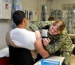 Service member receives vaccine