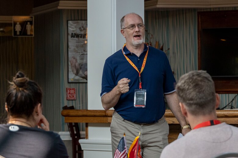 Mr. Jim Dietz, a hall of fame coach, presents a practical application brief to his fellow coaches at the coaches workshop on Marine Corps Base Quantico, Va, May 10, 2023. Coaches from across the nation travelled here to learn about the Marine Corps' officer programs. The purpose of the workshop is to create a mutually beneficial relationship between coaches and the Corps, where coaches share knowledge based on first-hand experience with colleagues, students and athletes. (U.S. Marine Corps photo by Cpl. Levi Voss)