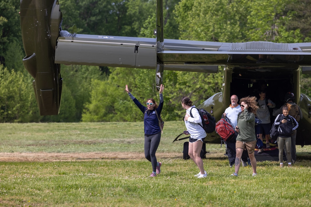 College coaches and educators exit a MV-22 B 'Osprey' flown by the pilots of Marine Helicopter Squadron One while attending the Coaches Workshop hosted by the Marine Corps Recruiting Command at Marine Corps Base Quantico, Va., on May 11, 2023. Upon completion of the workshop, attending coaches and educators will return to their schools and community equipped with a better understanding of the Marine Corps and ability to tell the Marine Corps story. (U.S. Marine Corps photo by Lance Cpl. Payton Goodrich)