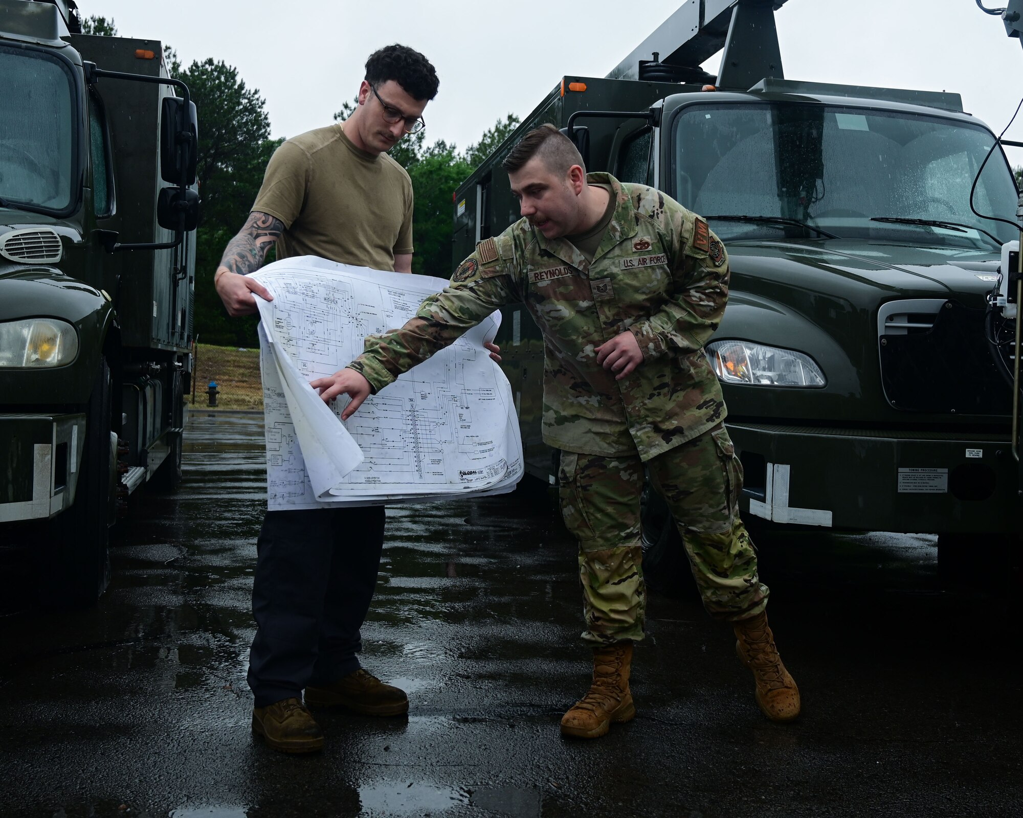 A man in uniform folds a map.