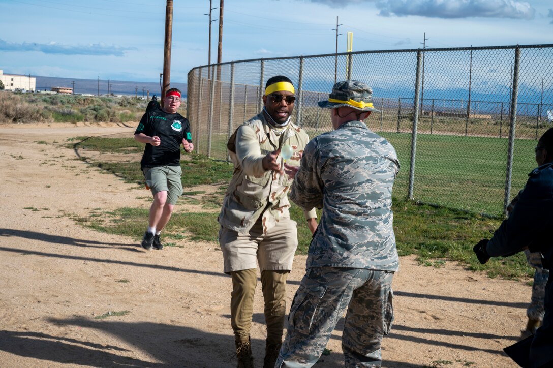 U.S. Air Force Airmen assigned to the 412th Mission Support Group participate in a water balloon race during a combat dining-in at Edwards Air Force Base, California, May 4, 2023. The 412th MSG hosted the event to bring Airmen together and build camaraderie.