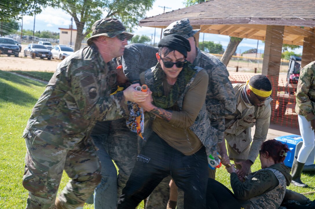 U.S. Air Force Airmen assigned to the 412th Mission Support Group participate in water games during a combat dining-in at Edwards Air Force Base, California, May 4, 2023. A combat dining-in is a military tradition that allows Airmen to develop esprit de corps.