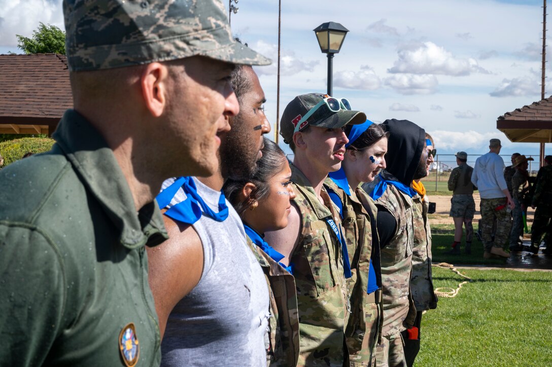 U.S. Air Force Airmen assigned to the 412th Mission Support Group stand before the 412th MSG commander at the combat dining-in at Edwards Air Force Base, California, May 4, 2023. During the event, Airmen who violated set rules were ordered to report to the commander for their punishment.