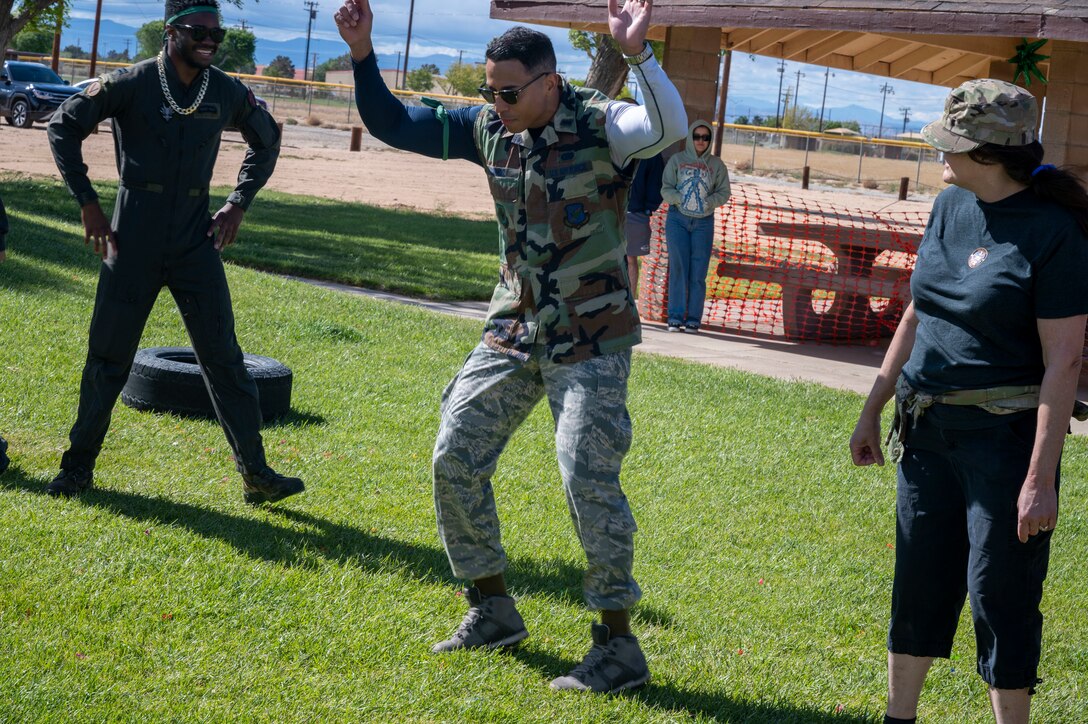 Lt. Col. Margell Munoz, Commander, 412th Communications Squadron competes at a dance off at the combat dining-in event at Edwards Air Force Base, California, May 4, 2023. The 412th MSG hosted the event to bring current and newer Airmen together and build camaraderie among each other in a competitive manner.
