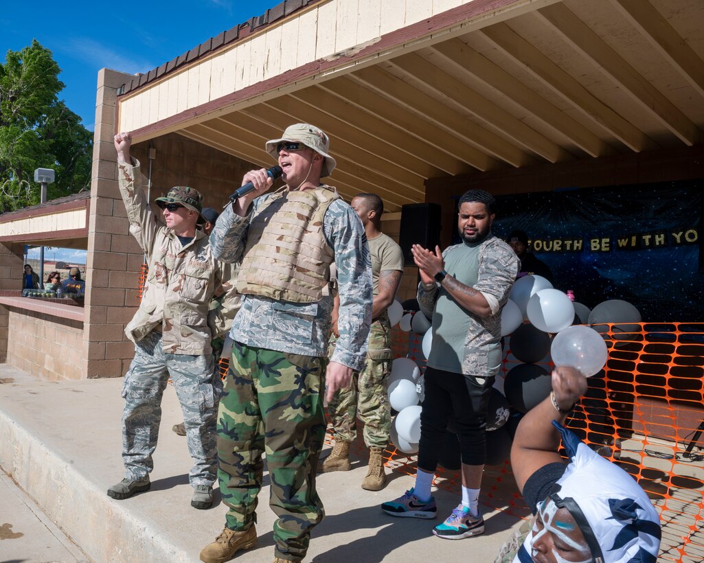 CMSgt. Jeremy Swistak, Senior Enlisted Leader, 412th Mission Support Group and Col. Jarod Blecher, Commander, 412th Mission Support Group speak to the Airmen at the combat dining-in event at Edwards Air Force Base, California, May 4, 2023.  The 412th MSG hosted the event to bring current and newer Airmen together and build camaraderie among each other in a competitive manner.