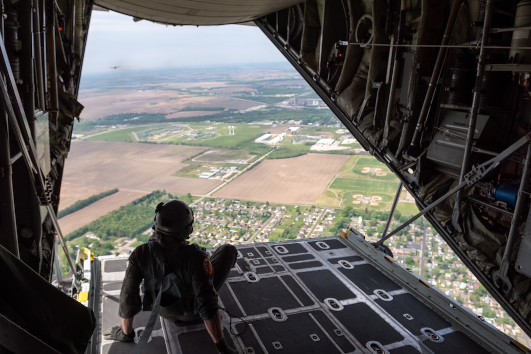 U.S. Air Force Airman 1st Class Ian Diehl, a C-130 loadmaster with the 169th Airlift Squadron, observes the rear view out a C-130H Hercules aircraft during a “Breakfast with the Boss” Boss Lift at the 182nd Airlift Wing in Peoria, Illinois, May 11, 2023.