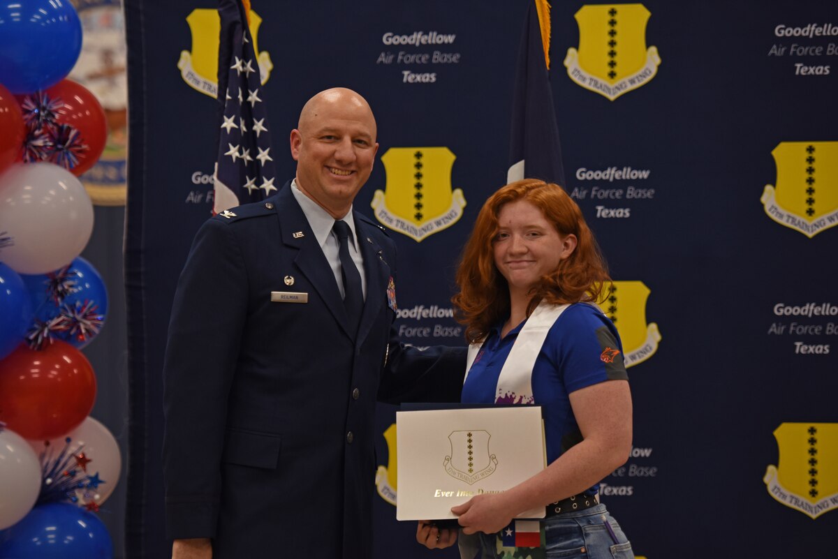 U.S. Air Force Col. Matthew Reilman, 17th Training Wing commander, and Veronica Ross, Central High School student, pose for a photo at the Goodfellow Air Force Base Armed Forces Commitment Celebration, at Goodfellow AFB, Texas, May 12. Ross is going to Angelo State University where she will be in the Reserve Officers’ Training Corps. (U.S. Air Force photo by Senior Airman Ashley Thrash)