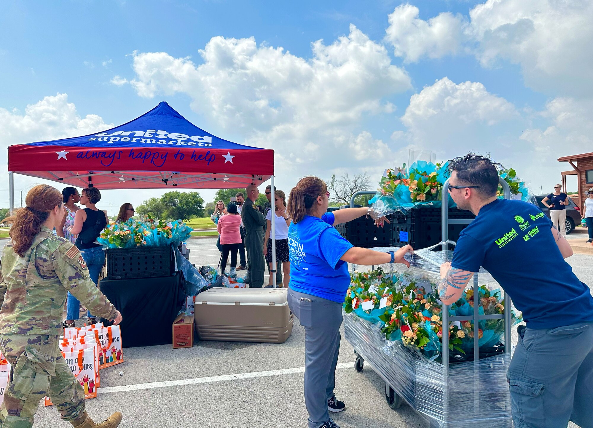 Dyess personnel prepare bouquets of flowers at a Military Spouse Appreciation Day event at Dyess Air Force Base, Texas, May 12, 2023. Bouquets of flowers and goodie bags were distributed to military spouses to honor them for their support and sacrifices. The first Military Spouse Appreciation Day was declared in 1984 by President Ronald Reagan; the day now falls on the Friday before Mother’s Day. (U.S. Air Force photo by Airman 1st Class Emma Anderson)