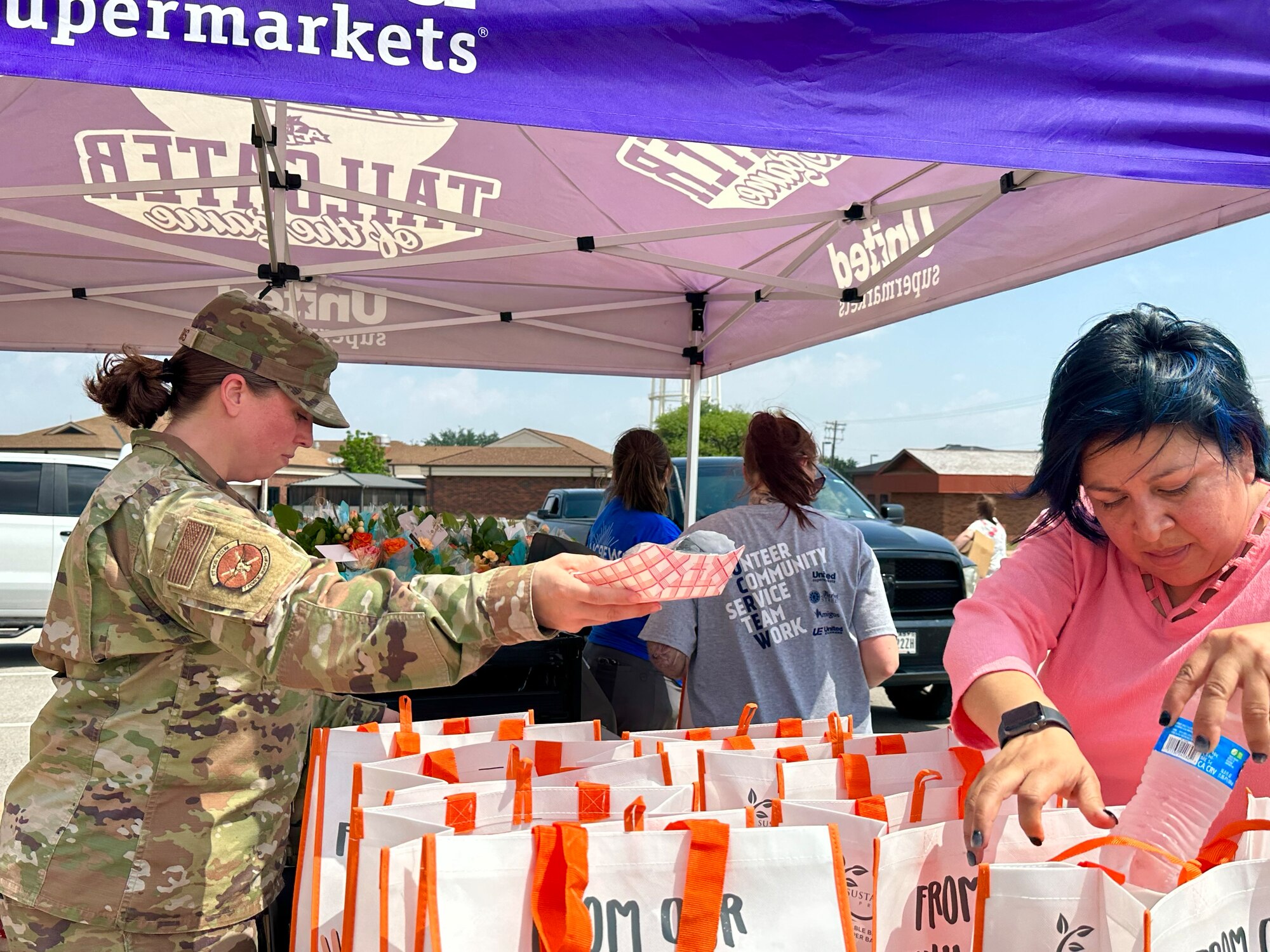 Dyess personnel hand out hot dogs and beverages at a Military Spouse Appreciation Day event at Dyess Air Force Base, Texas, May 12, 2023. Bouquets of flowers and goodie bags were distributed to military spouses to honor them for their support and sacrifices. The first Military Spouse Appreciation Day was declared in 1984 by President Ronald Reagan; the day now falls on the Friday before Mother’s Day. (U.S. Air Force photo by Airman 1st Class Emma Anderson)