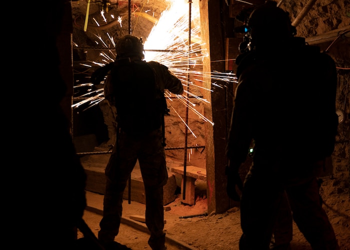 U.S. Air Force pararescuemen remove rebar blocking their path during an exercise at the San Xavier Mine, Ariz., May 4, 2023. The pararescuemen participated in a simulated rescue situation at the mine. (U.S. Air Force photo by Airman William Finn V)