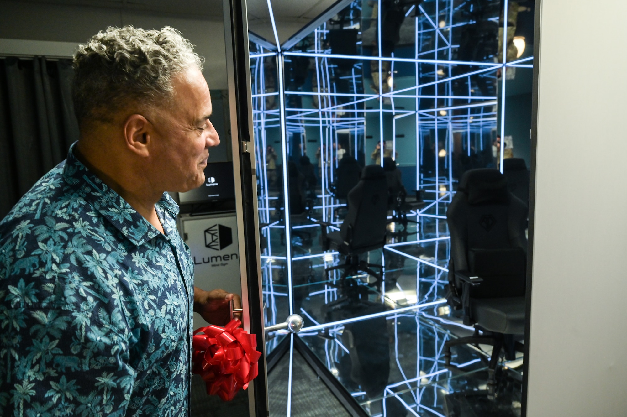Dr. John Duarte, 15th Wing prevention team coordinator, opens the door of a Lumena MindGym in Hangar 2 at Joint Base Pearl Harbor-Hickam, Hawaii, May 12, 2023. The MindGym creates a sensory deprivation, bio-responsive mindfulness environment, providing Team Hickam with an additional tool to build resiliency and improve mental health. (U.S. Air Force photo by Staff Sgt. Alan Ricker)