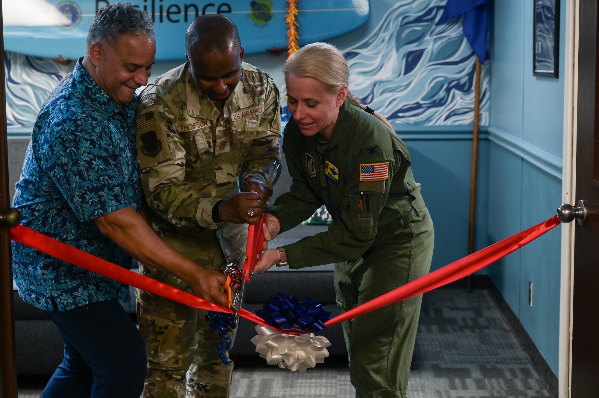 Dr. John Duarte, 15th Wing prevention team coordinator, Chief Master Sgt. Anthony Thompson Jr., 15th Wing command chief, and Col. Michele Lo Bianco, 15th Wing commander, cut a ribbon during the opening of a Lumena MindGym in Hangar 2 at Joint Base Pearl Harbor-Hickam, Hawaii, May 12, 2023. Team Hickam is the fourth Air Force representative to implement a MindGym, providing an additional tool to build resiliency and improve mental health. (U.S. Air Force photo by Staff Sgt. Alan Ricker)