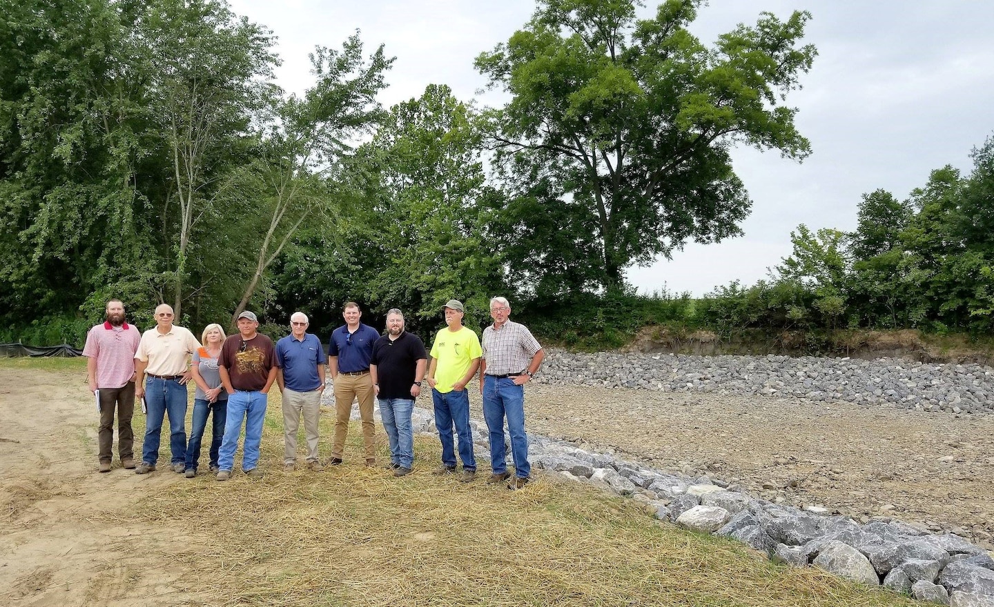 The Ramsey Creek Scour Repair project, which began on July 17, 2018, repaired a bank scour that threatened the integrity of the Little River Headwater Diversion Levee near Scott City, Missouri. 

Bank scour is the washing-away of bank soil and other materials by the force of natural water current. The Ramsey Creek bank scour could have potentially caused a breach in the Little River Headwater Diversion Levee, which is a flood control structure that protects nearby communities, lands, and infrastructure from flooding. The scour repair halted further bank erosion and potential damage to the levee, eliminating the threat of a levee breach and flooding.
The U.S. Army Corps of Engineers Memphis District managed the project in partnership with the Little River Drainage District as the project’s sponsor. The prime contractor, completing the work on the project, was D.W. Mertzke General Contractors along with sub-contractor Donald Bond Construction  .

Representatives from each of the organizations gathered at the project site on Aug.15 to conduct the final completed work inspection.

Pictured, from left to right, are Grayson Holt, Memphis District (project designer); Mark Games, D.W. Mertzke, (prime contractor); Chrissy Henderson, D.W. Mertzke; Mike Clark, Memphis District (project inspector); Donald Bond, Donald Bond Construction (sub-contractor); W. Dustin Boatwright, the Little River Drainage District’s executive vice president and chief engineer; Daimon McNew, the Memphis District’s Caruthersville Office area engineer; Mark Broughton, Donald Bond Construction; and Jack Ratliff, Memphis District (project lead civil engineer). Eric White, not pictured, was the Memphis District's operations project manager.