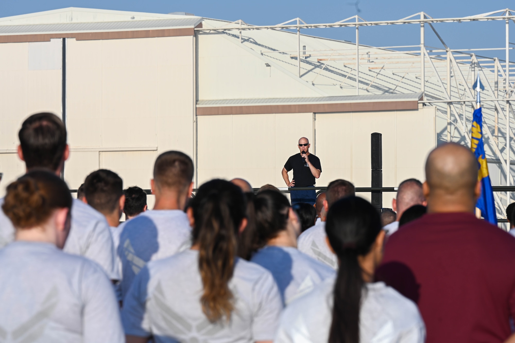 U.S. Air Force Col. Blaine Baker, 97th Air Mobility Wing (AMW) commander, speaks to Airmen from the 97th AMW during a training day at Altus Air Force Base, Oklahoma, May 12, 2023. The wing utilizes training days to enhance both physical, mental and professional development for Airmen. (U.S. Air Force photo by Senior Airman Trenton Jancze)