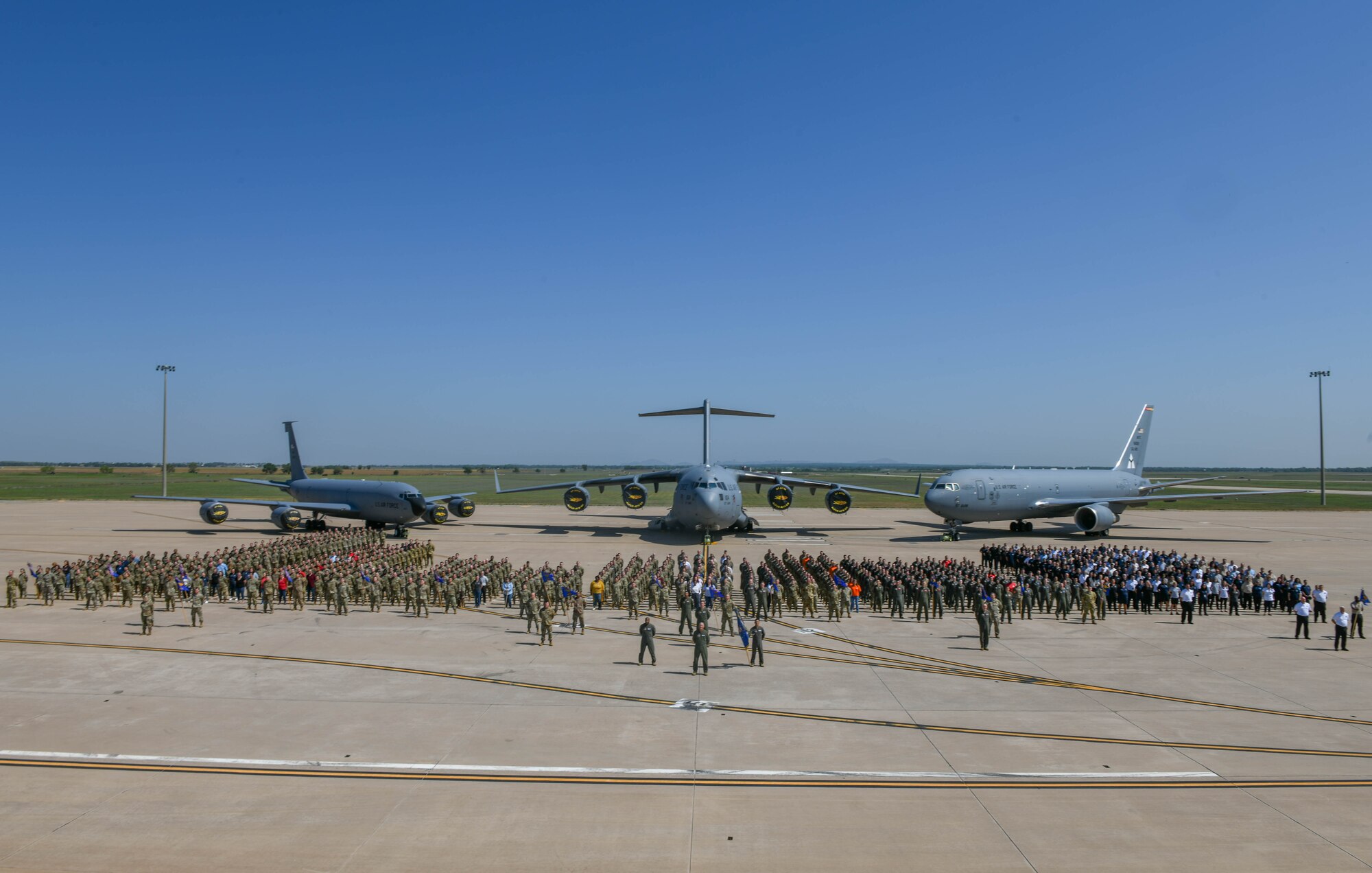 Airmen from the 97th Air Mobility Wing (AMW) pose for a photo at Altus Air Force Base, Oklahoma, May 12, 2023. The 97th AMW is composed of almost 1,300 active military personnel and about 1,200 civilians. (U.S. Air Force photo by Senior Airman Trenton Jancze)
