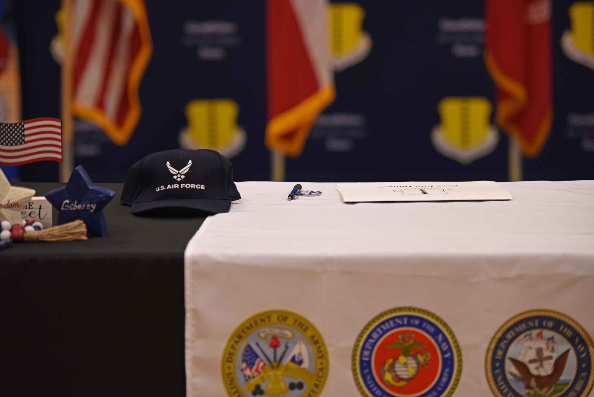 A U.S. Air Force hat and commitment letter sit on a table at the Goodfellow Air Force Base Armed Forces Commitment Celebration, at Goodfellow AFB, Texas, May 12. 13 students from Central High School and Lake View High School celebrated their commitment, whether it be the Reserve Officers’ Training Corps, going active duty or attending military academies. (U.S. Air Force photo by Senior Airman Ashley Thrash)