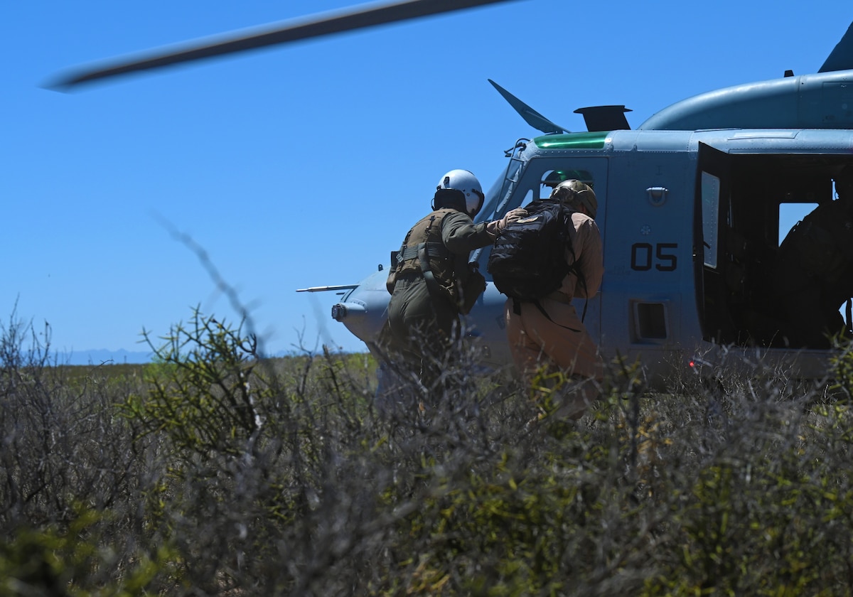 A U.S. Marine recovers a simulated victim to the safety of a UH-1Y Venom Huey utility helicopter during a RED FLAG-Rescue 23-1 training exercise at Playas Training Center, New Mexico, May 9, 2023. The joint training environment allowed service members to showcase their professionalism, agility, and adaptability while serving with the highest level of integrity and commitment to their own service, the joint force and the U.S. (U.S. Air Force photo by Staff Sgt. Abbey Rieves)