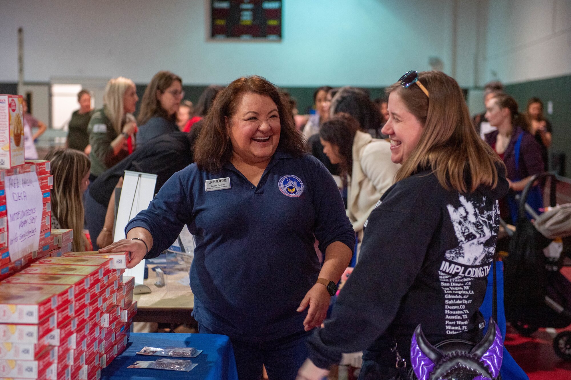 Teresa Carrillo, Military and Family Readiness Center community readiness consultant, discusses available programs with a military spouse during a Military Spouse Appreciation Day event at Ramstein Air Base, Germany, May 12, 2023. During the event, spouses received information on resources from different organizations, in support of the 86th Airlift Wing’s priority of investing in Airmen and their families.