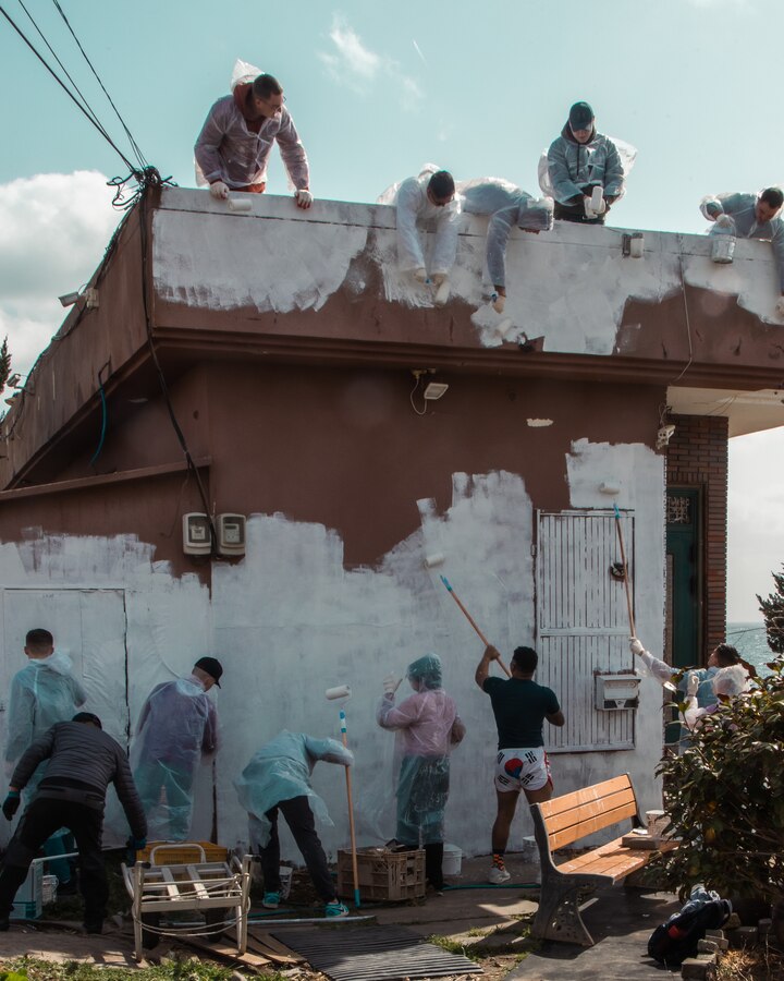 U.S. Marines and Navy Sailors paint a house during a village restoration project at Damupo Village, South Korea, on March 25, 2023. On Aug. 29, 2022, Typhoon Hinnamnor overtook the village and severely damaged the structures. To help the village recover from the natural disaster, Marines and local residents came together to repaint the damaged homes. (U.S. Marine Corps photo by Lance Cpl. Jonathan Beauchamp)