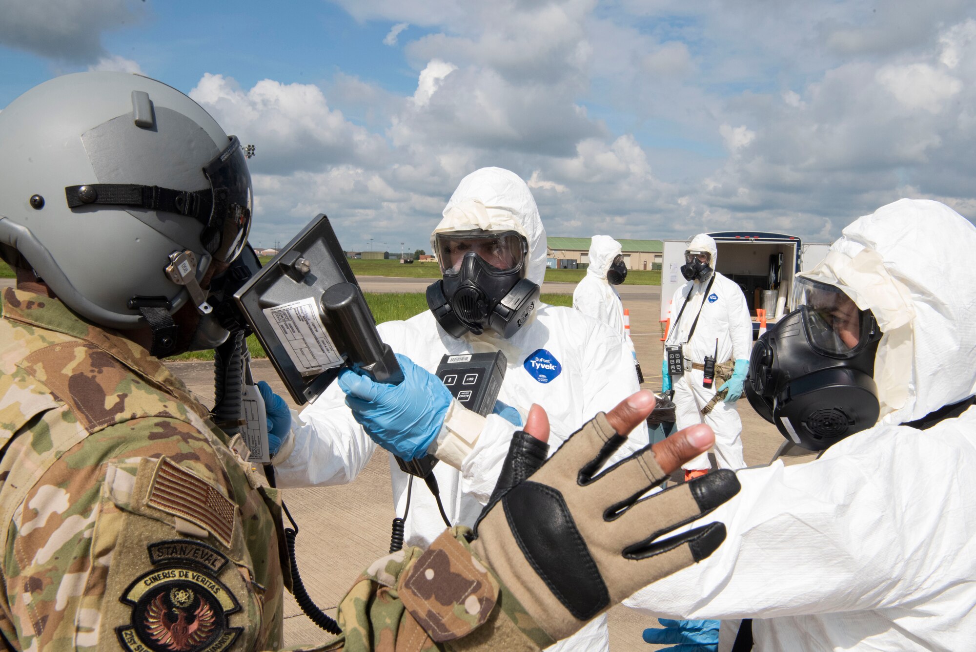 U.S. Air Force Airman 1st Class Ethan Harlan and Airman 1st Class Miranda Dickinson, 100th Civil Engineer Squadron emergency management journeymen scans Staff Sgt. Victor Williams, 21st Surveillance Squadron Detachment 1 special equipment operator for contamination during an Aircraft Radiological Recovery Plan training event at Royal Air Force Mildenhall, England, May 11, 2023. The WC-135 Constant Phoenix aircraft is currently the only aircraft in the Air Force inventory that conducts air sampling operations. The ability to evaluate radionuclides in the atmosphere enhances the Air Force Technical Applications Center’s ability to monitor Limited Test Ban Treaty of 1963 compliance. (U.S. Air Force photo by Tech. Sgt. Anthony Hetlage)