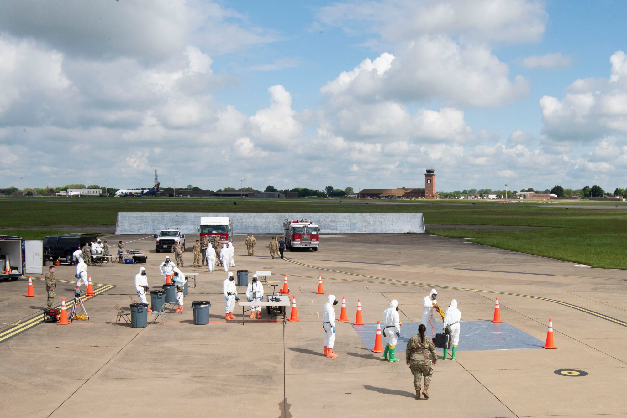 U.S. Airmen assigned to the 100th Air Refueling Wing, 55th Wing, 48th Fighter Wing and the Air Force Technical Applications Center prepare to receive personnel from a WC-135 Constant Phoenix aircraft during an Aircraft Radiological Recovery Plan training event at Royal Air Force Mildenhall, England, May 11, 2023. The event provided realistic training to assist in unit interoperability while maintaining proficiency for aircraft recovery personnel. (U.S. Air Force photo by Tech. Sgt. Anthony Hetlage)