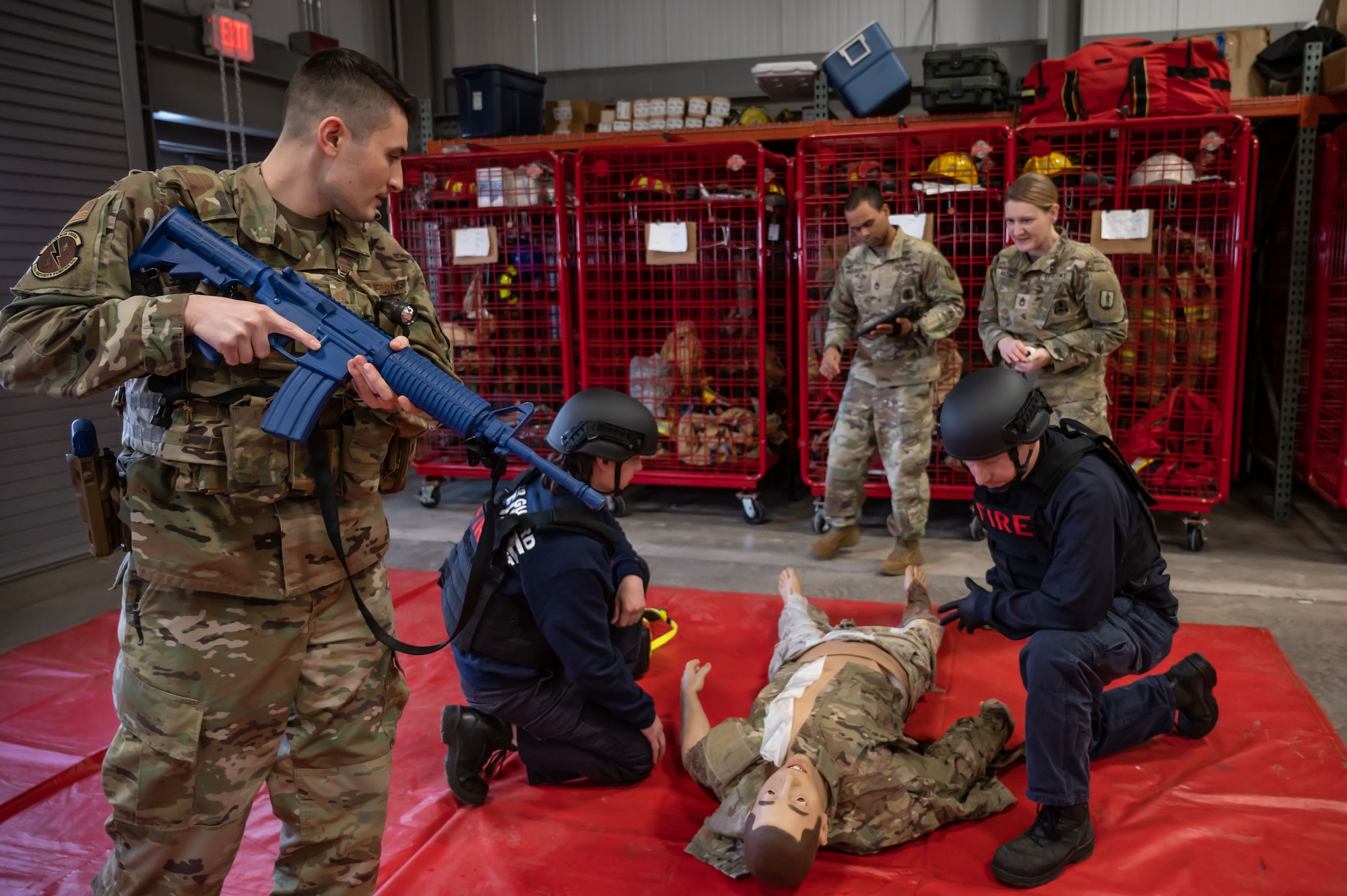 Members of the Connecticut National Guard Fire and Emergency Services, alongside 103rd Medical and Security Forces Squadrons perform Tactical Combat Casualty Care on a high fidelity training manikin at Bradley Air National Guard Base, East Granby, Connecticut, March 8, 2023. TCCC is the fundamentals of life-saving techniques developed for service members to provide trauma care in all situations.(U.S. Air National Guard photo by Master Sgt. Tamara Dabney)