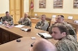 Lt. Col. Gordon Kinneer, second from left, commander, 1st Squadron, 104th Cavalry Regiment, 2nd Infantry Brigade Combat Team, and Maj. Rich Fowler, left, 1-104th Cav. executive officer, meet with soldiers from Lithuania's Uhlan Battalion May 4, 2023, in Alytus, Lithuania. (Courtesy photo)