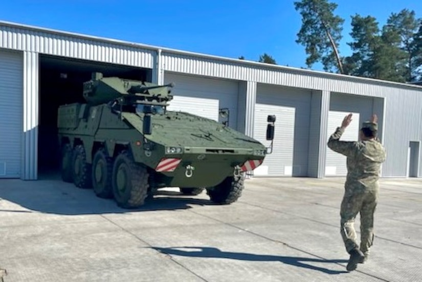 A soldier from Lithuania's Uhlan Battalion guides a Vilkas infantry fighting vehicle during a visit by Pennsylvania National Guard Soldiers from 1st Squadron, 104th Cavalry Regiment, 2nd Infantry Brigade Combat Team May 4, 2023, in Alytus, Lithuania. (Courtesy photo)