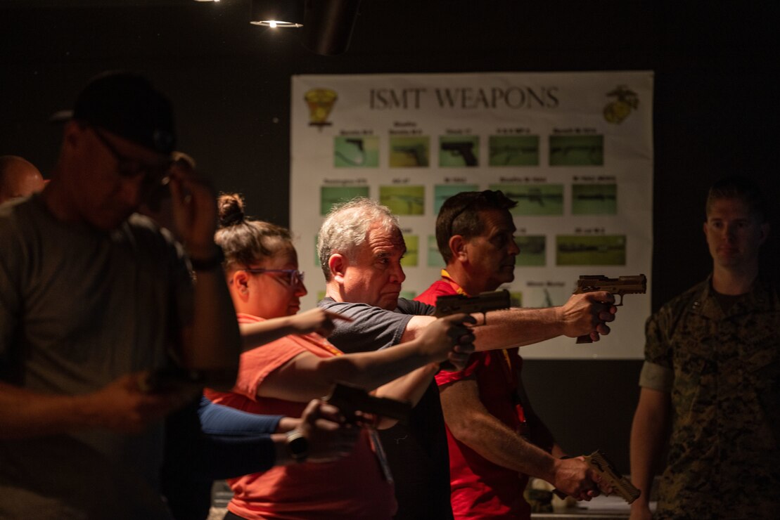 Miguel Centeno, vice-dean, Princeton School of Public and International Affairs, along with other coaches and educators utilize the Indoor Simulated Marksmanship Trainer at The Basic School in Quantico, Va. Attendees were part of the Coaches Workshop hosted by the Marine Corps Recruiting Command at Marine Corps Base Quantico, Va., May 9-13, 2023. Upon completion of the workshop, attending coaches and educators will return to their schools and community equipped with a better understanding of the Marine Corps and ability to tell the Marine Corps story. (U.S. Marine Corps photo by Lance Cpl. Payton Goodrich)