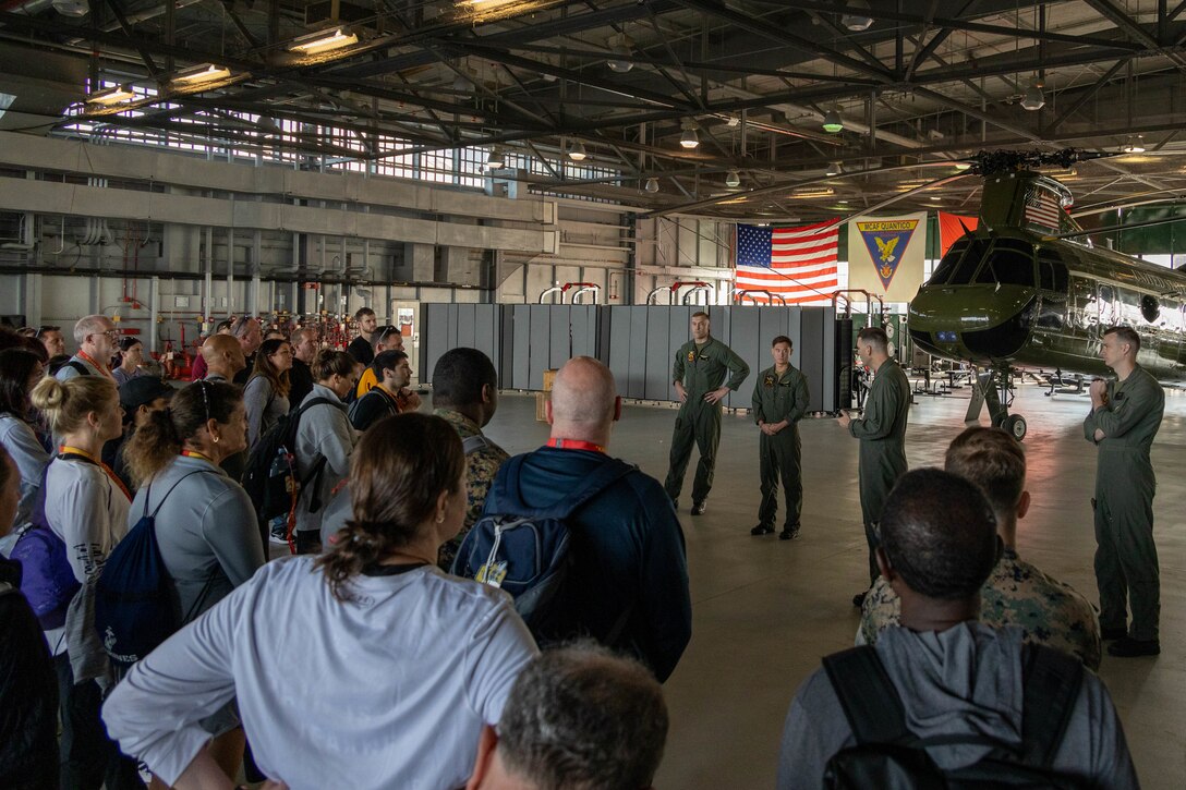 College coaches and educators receive a brief before riding in an Marine Helicopter Squadron One MV-22B 'Osprey' during attending the Coaches Workshop hosted by the Marine Corps Recruiting Command at Marine Corps Base Quantico, Va., May 11, 2023. Upon completion of the workshop, attending coaches and educators will return to their schools and community equipped with a better understanding of the Marine Corps and the ability to tell the Marine Corps story. (U.S. Marine Corps photo by Lance Cpl. Gustavo Romero)