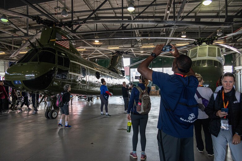 College coaches and educators observe past aircraft flown by Marine Helicopter Squadron One pilots while attending the Coaches Workshop hosted by the Marine Corps Recruiting Command at Marine Corps Base Quantico, Va., May 11, 2023. Upon completion of the workshop, attending coaches and educators will return to their schools and community equipped with a better understanding of the Marine Corps and the ability to tell the Marine Corps story. (U.S. Marine Corps photo by Lance Cpl. Gustavo Romero)