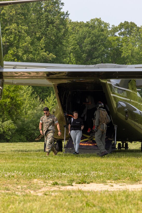College coaches and educators exit a MV-22 B 'Osprey' flown by Marine Helicopter Squadron One pilots while attending the Coaches Workshop hosted by the Marine Corps Recruiting Command at Marine Corps Base Quantico, Va., on May 11, 2023. Upon completion of the workshop, attending coaches and educators will return to their schools and community equipped with a better understanding of the Marine Corps and ability to tell the Marine Corps story. (U.S. Marine Corps photo by Lance Cpl. Payton Goodrich)