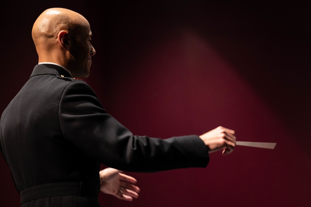 U.S. Marine Chief Warrant Officer 2 Eric Kyne, the officer in charge of the 1st Marine Division Band, conducts his ensemble during a performance at the Pacific Coast Regional Wind Band Festival in Long Beach, California, March 4, 2023. The festival consisted of 14 ensembles from high schools throughout California and gave the 1st MARDIV Band an opportunity to engage with the community and showcase their talent. Kyne is a native of West Hartford, Connecticut.  (U.S. Marine Corps photo by Cpl. Cameron Hermanet)