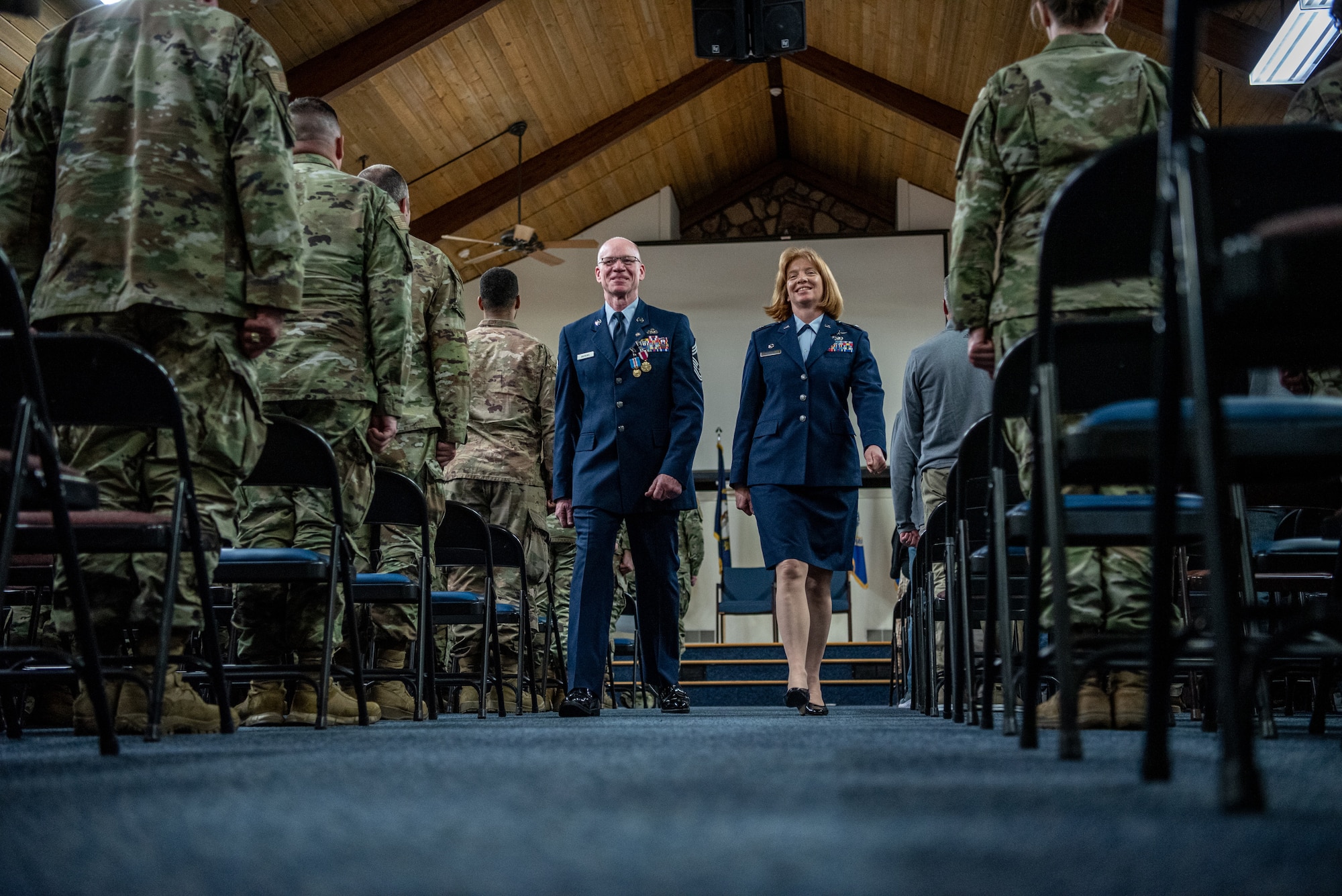 Chief Master Sgt. Scott Andrews, left, material management chief enlisted manager for the 123rd Logistics Readiness Squadron, and Lt. Col. Leslie Brooks, right, 123rd LRS commander, depart the stage after a ceremony at the Kentucky Air National Guard Base in Louisville, Ky., April 29, 2023, in which Andrews was officially retired from the Kentucky Air National Guard after 35 years of military service. (U.S. Air National Guard photo by Tech. Sgt. Joshua Horton)