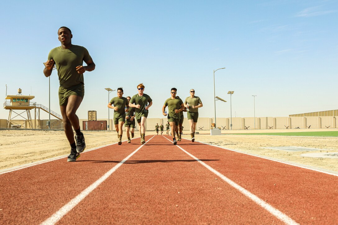 Marines run a on track.