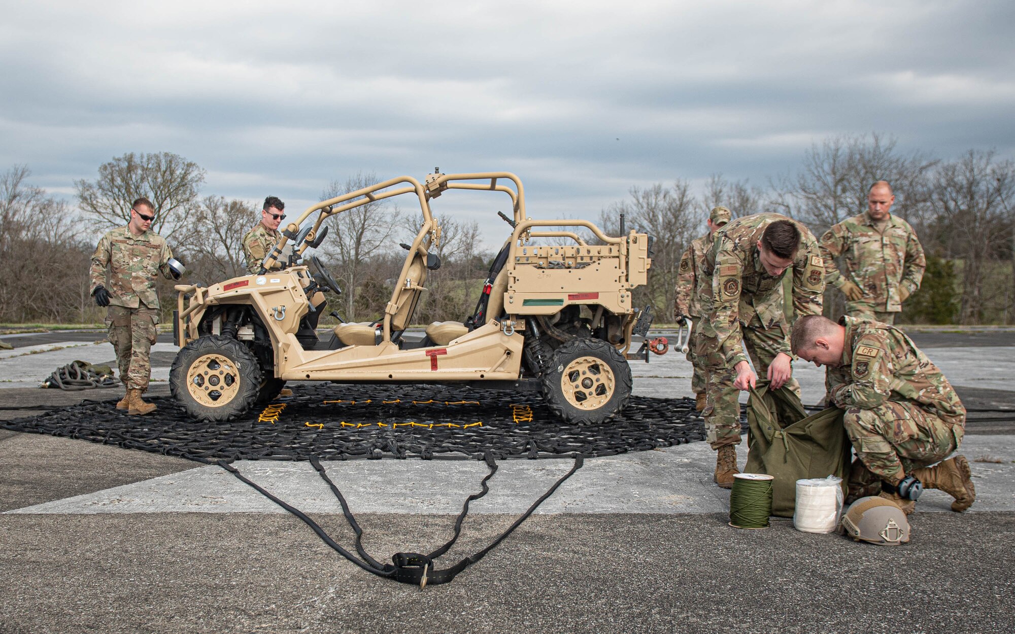 Airmen assigned to the Kentucky Air National Guard's 123rd Contingency Response Group train on hot-refueling techniques and prepare cargo for a helicopter-borne sling load carry at Boone National Guard Center in Frankfort, Ky., March 23, 2023. The training, conducted jointly with the Kentucky Army National Guard’s 63rd Theater Aviation Brigade, enhances the Air Guard unit’s ability to employ UH-60 Black Hawk helicopters in domestic and wartime environments. (U.S. Air National Guard photo by Staff Sgt. Clayton Wear)