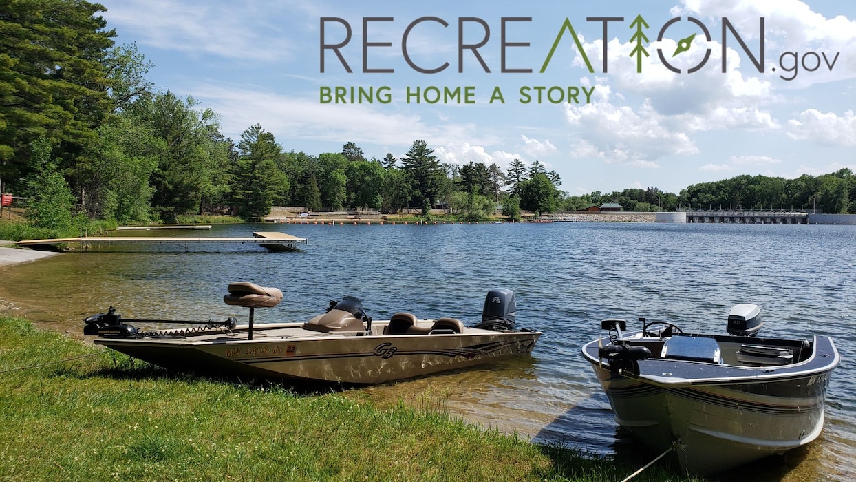 Two boats on a lake anchored to shore