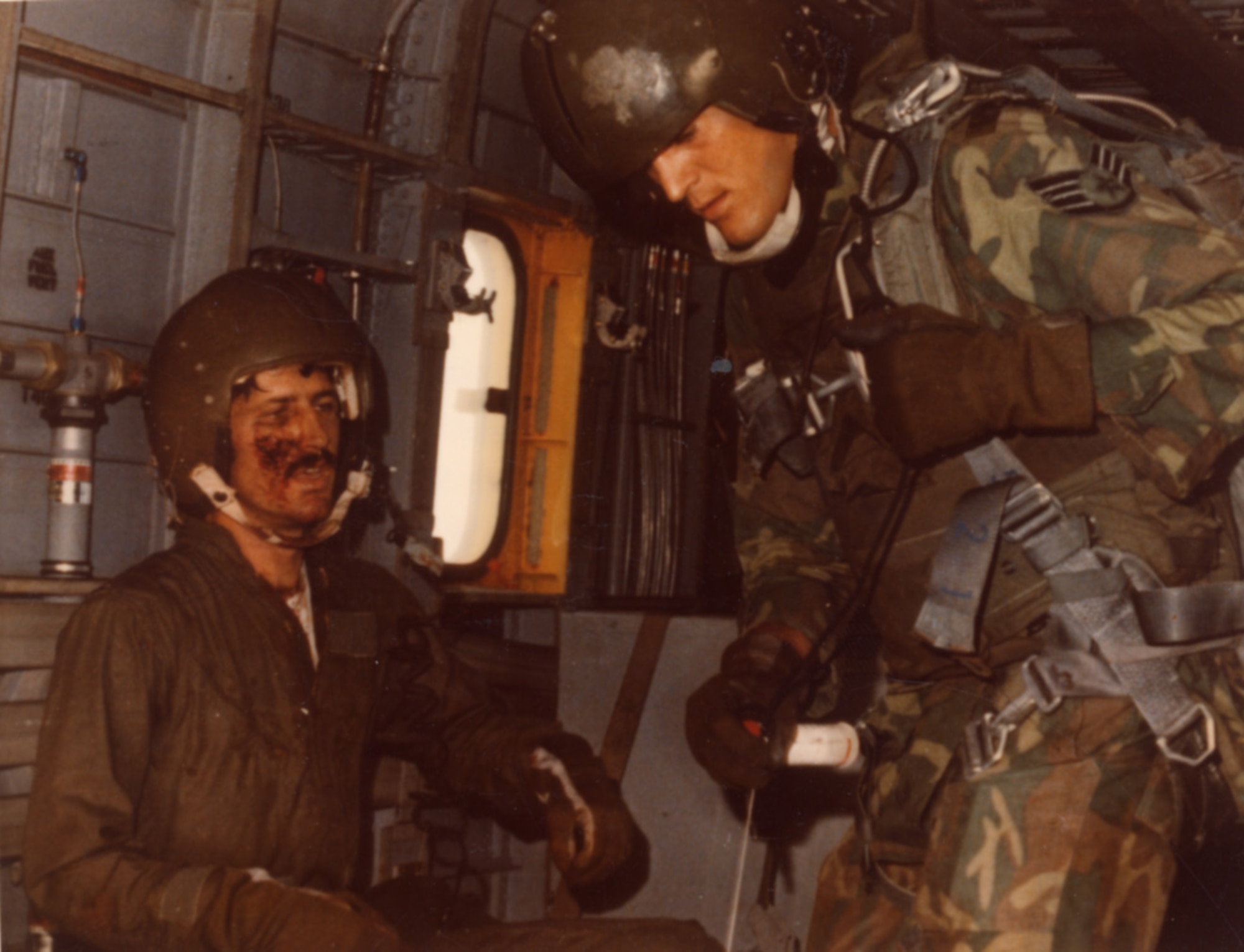 Lieutenant Fleming relaxes aboard the HH-43 helicopter following his rescue as a 40th ARR Squadron PJ reels in the rescue hoist on April 28, 1971.