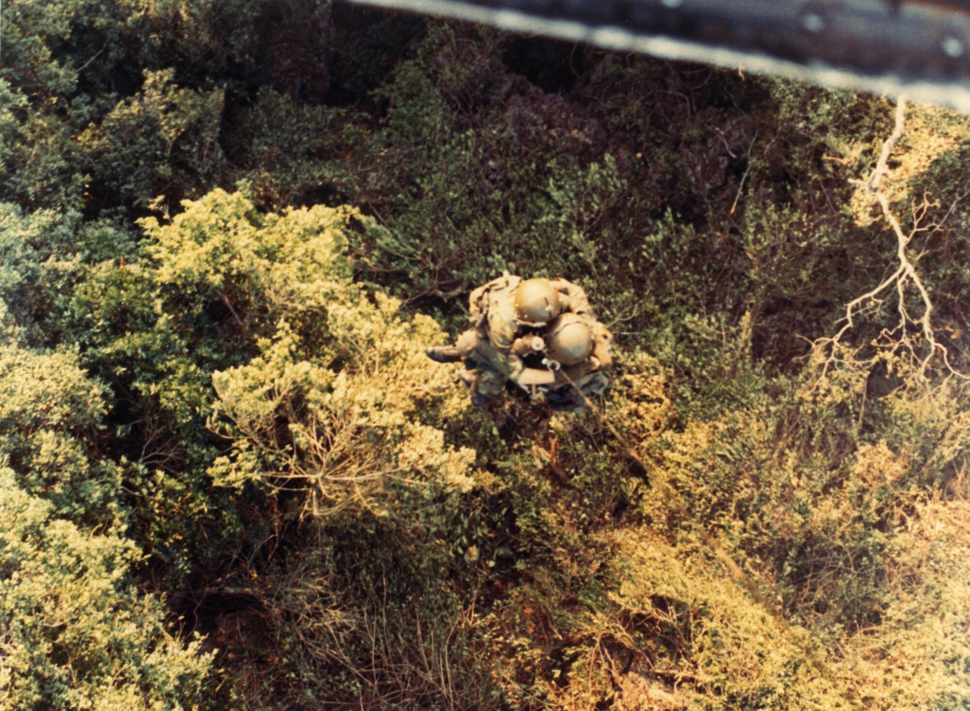 US Air Force pilot 1st Lt Glenn Fleming and a 40th ARR Squadron PJ are hoisted from the jungles of Laos by a USAF HH-43 helicopter on April 28, 1971.