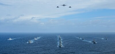 NATO ships transit the northern Atlantic Ocean as the French air force flies over the formation during Formidable Shield 23.