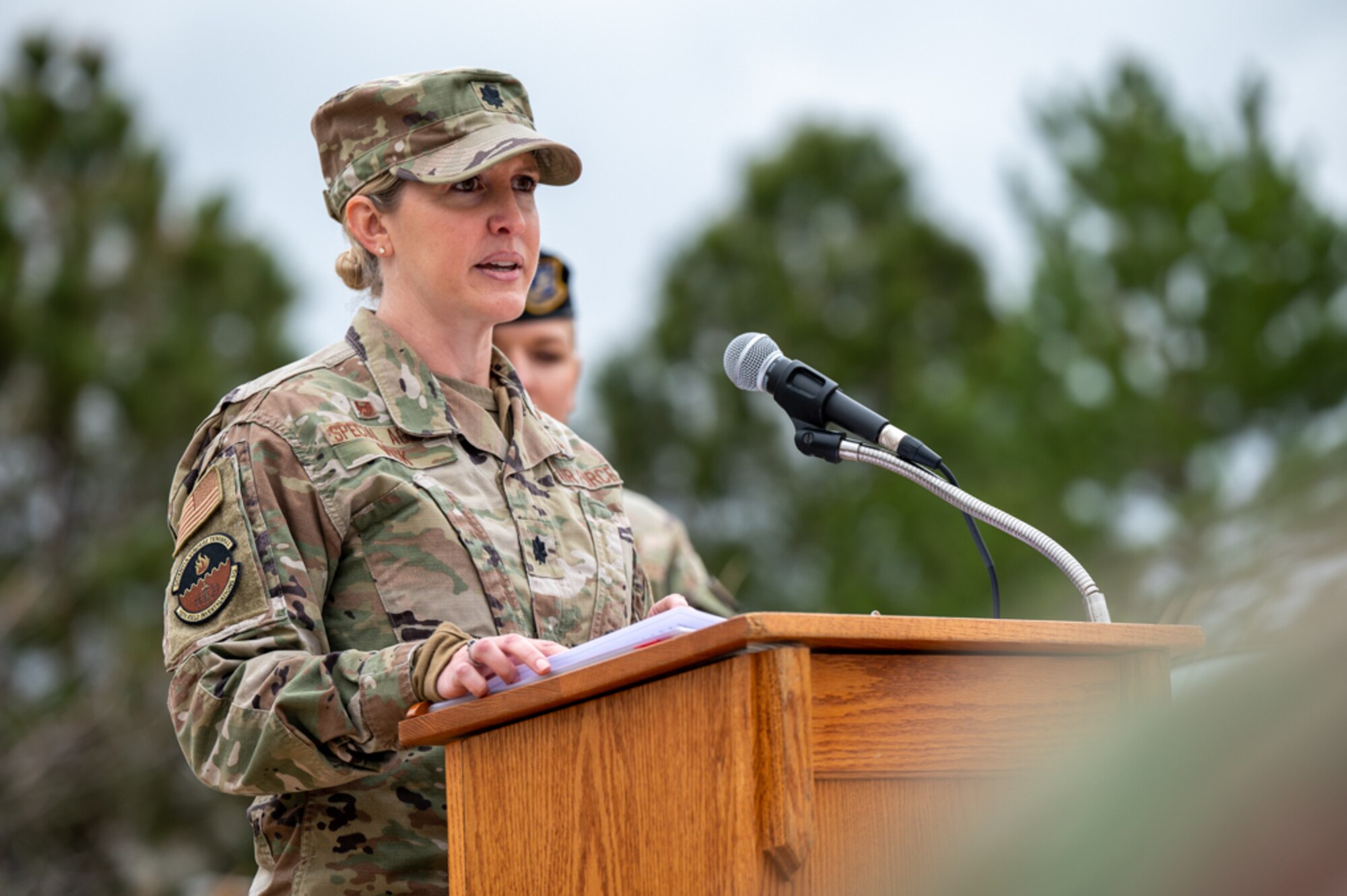 A Lt. Col. Speaks in front of a podium.