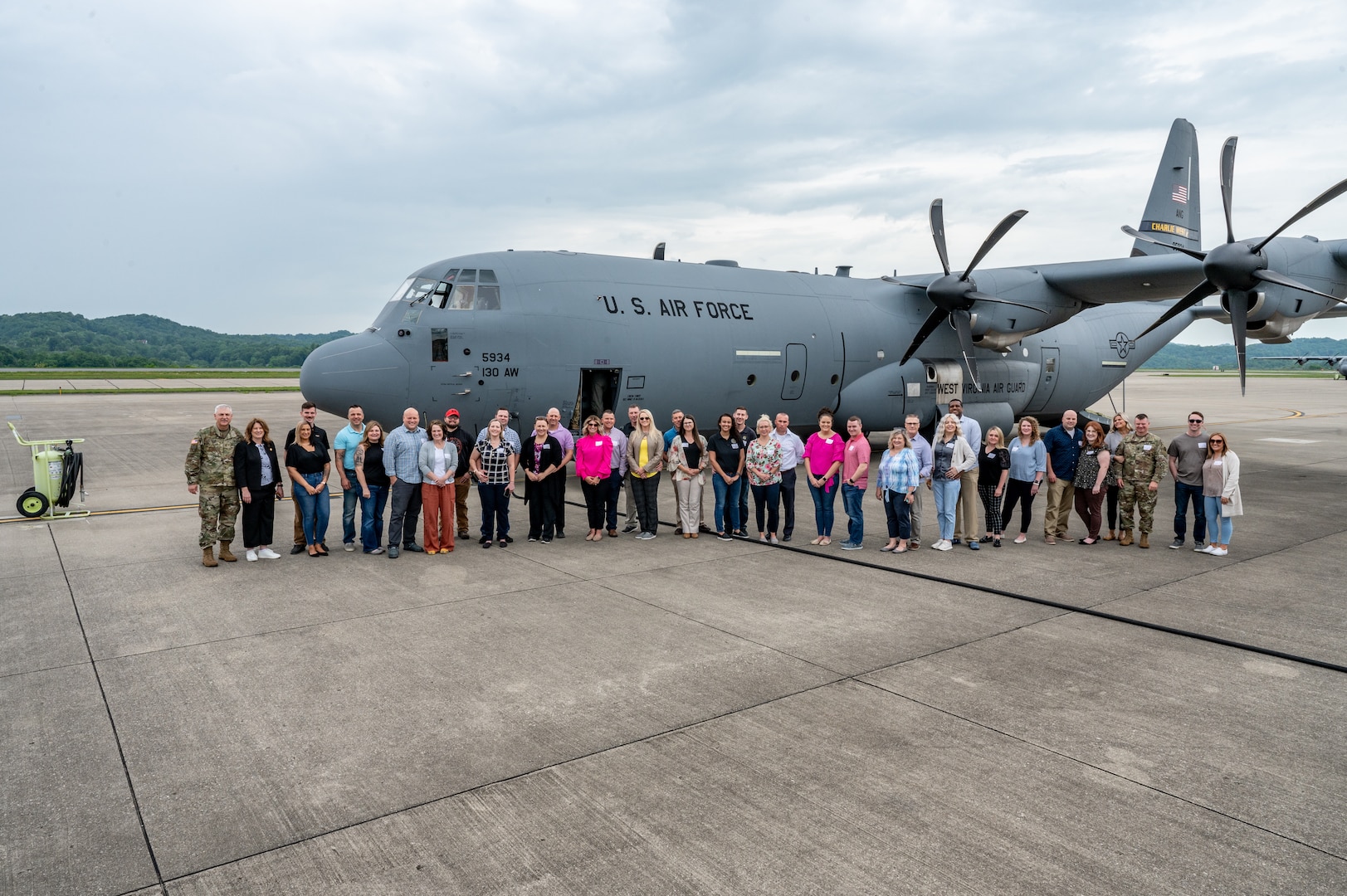Group photo from the West Virginia National Guard Military Spouse Appreciation Day event, 2023.About 40 people outside standing in from of a C-130 plane.