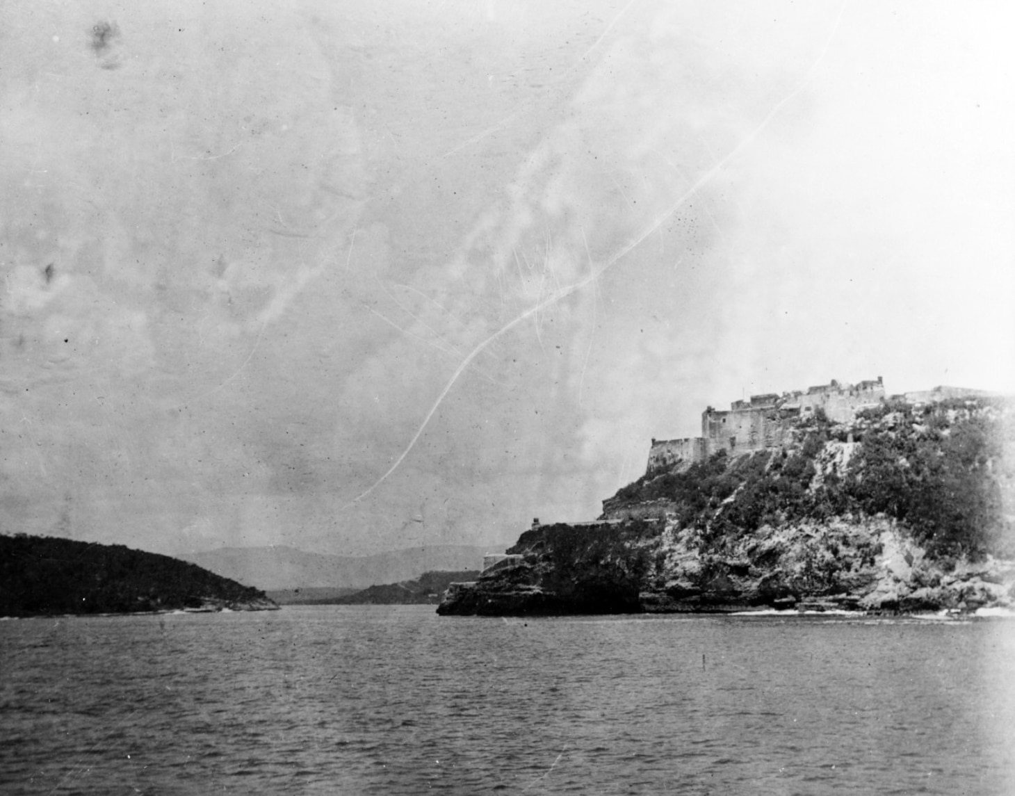The entrance to Santiago Bay was a narrow channel guarded by the Murro Castle, visible on the right hand side of this photograph. This channel made traditional naval reconnaissance impossible. Naval History and Heritage Command Photo