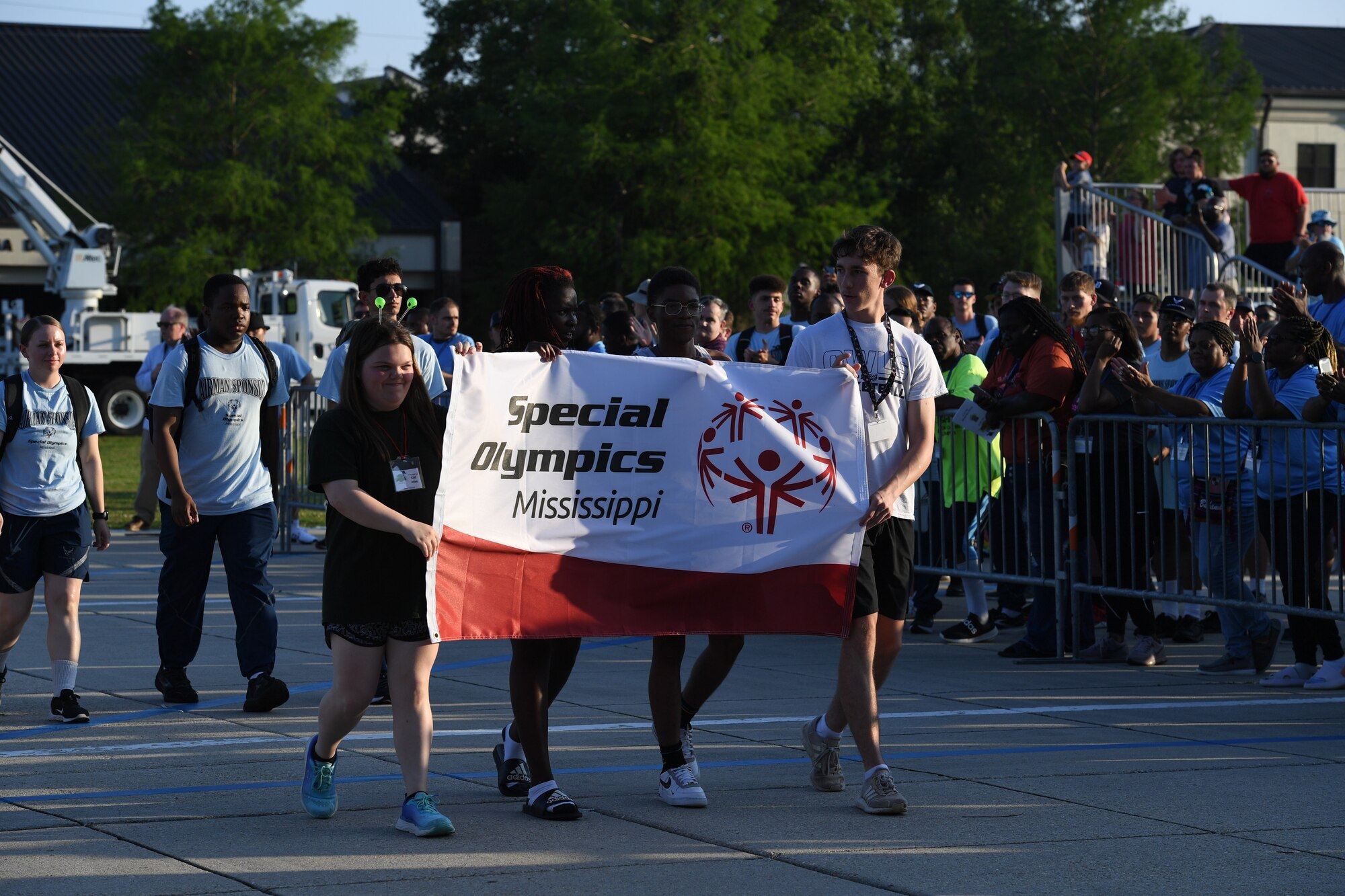 Special Olympics Mississippi athletes and 81st Training Wing members honor the flag during the SOMS Summer Games at Keesler Air Force Base, Mississippi, May 13, 2023.