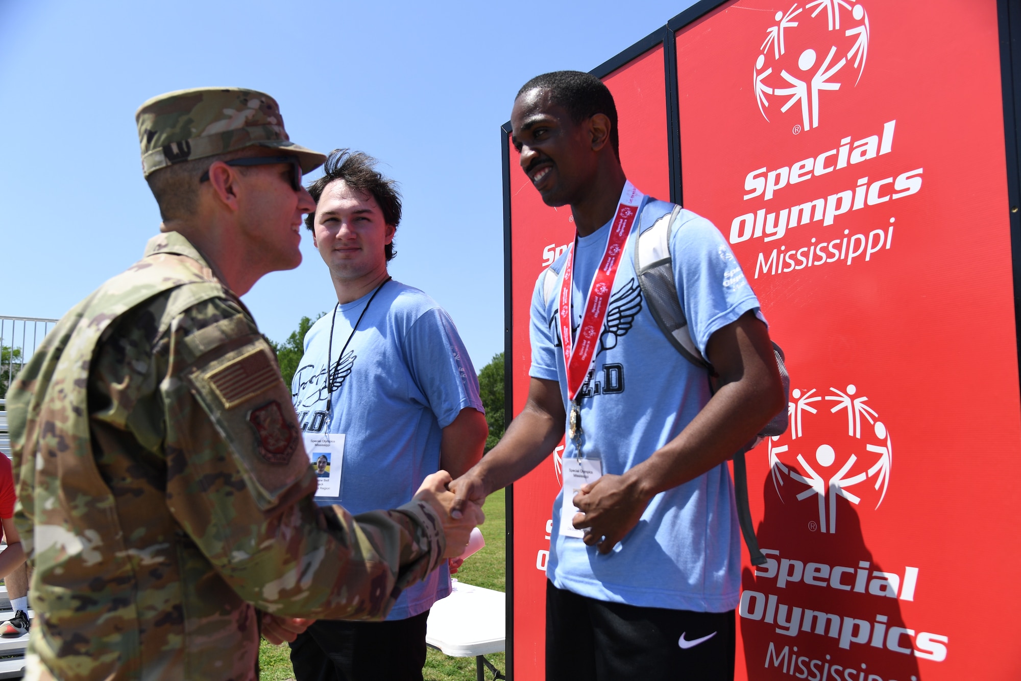 Special Olympics Mississippi athletes receive medals from 81st Training Wing leadership during the SOMS Summer Games at Keesler Air Force Base, Mississippi, May 13, 2023.