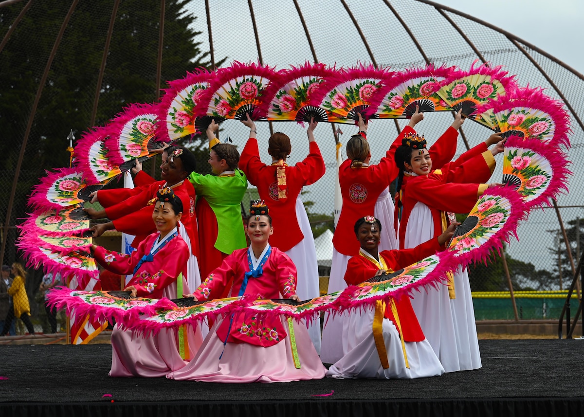 Students assigned to the 517th Training Squadron perform Buchaechum during Language Day at the Defense Language Institute Foreign Language Center, Calif., May 12, 2023. Buchaechum is a Korean fan dance originating from various traditional and religious Korean dances. (U.S. Air Force photo by Airman 1st Class Zach Heimbuch)