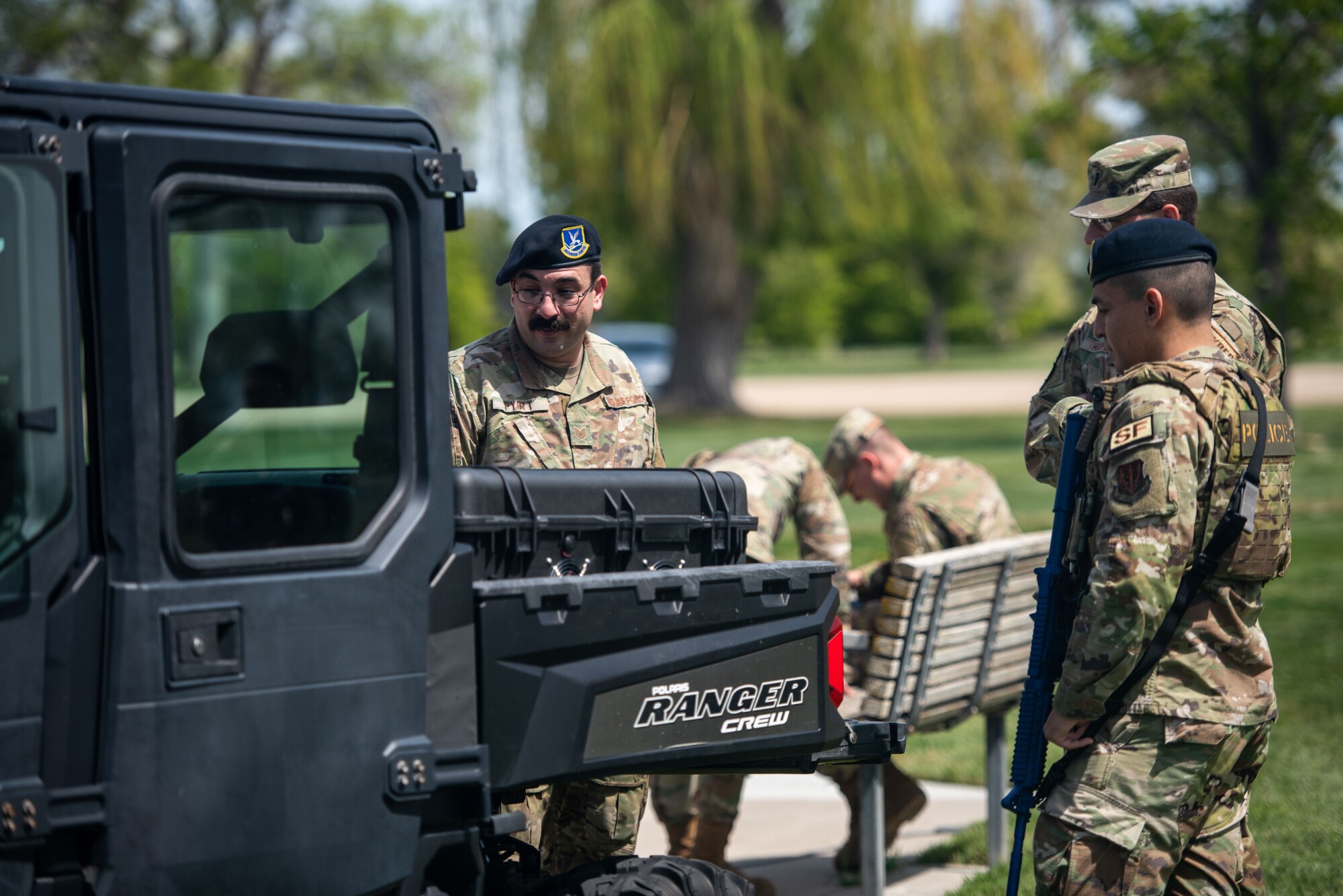 Airmen load equipment unto ATV.