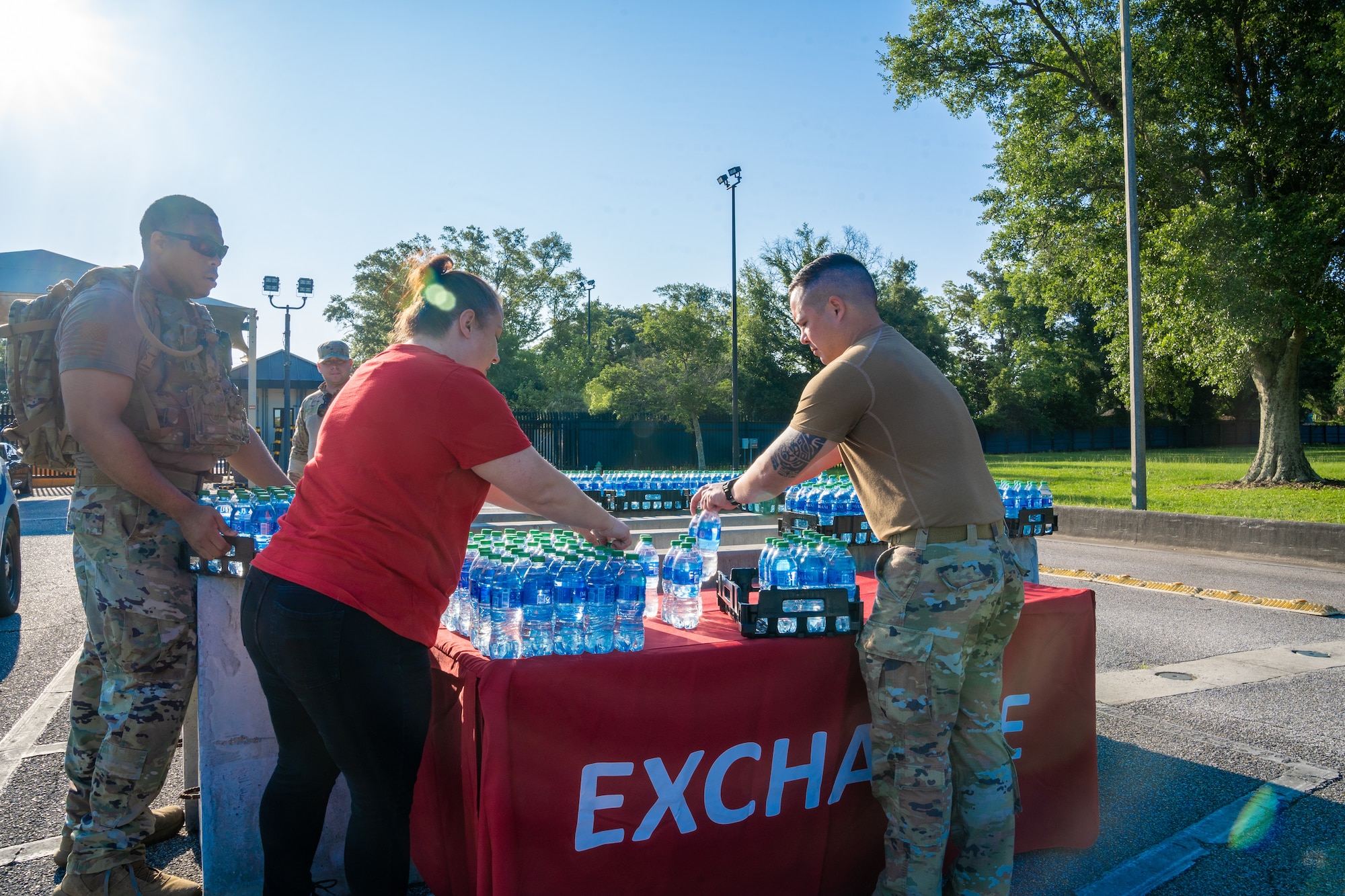 Stephanie Wainscott, Army & Air Force Exchange Services  stockroom manager, and Airmen from the 81st Security Forces Squadron set up a water station before the National Police Week 5K Memorial Ruck at Keesler Air Force Base, Mississippi, May 16, 2023.